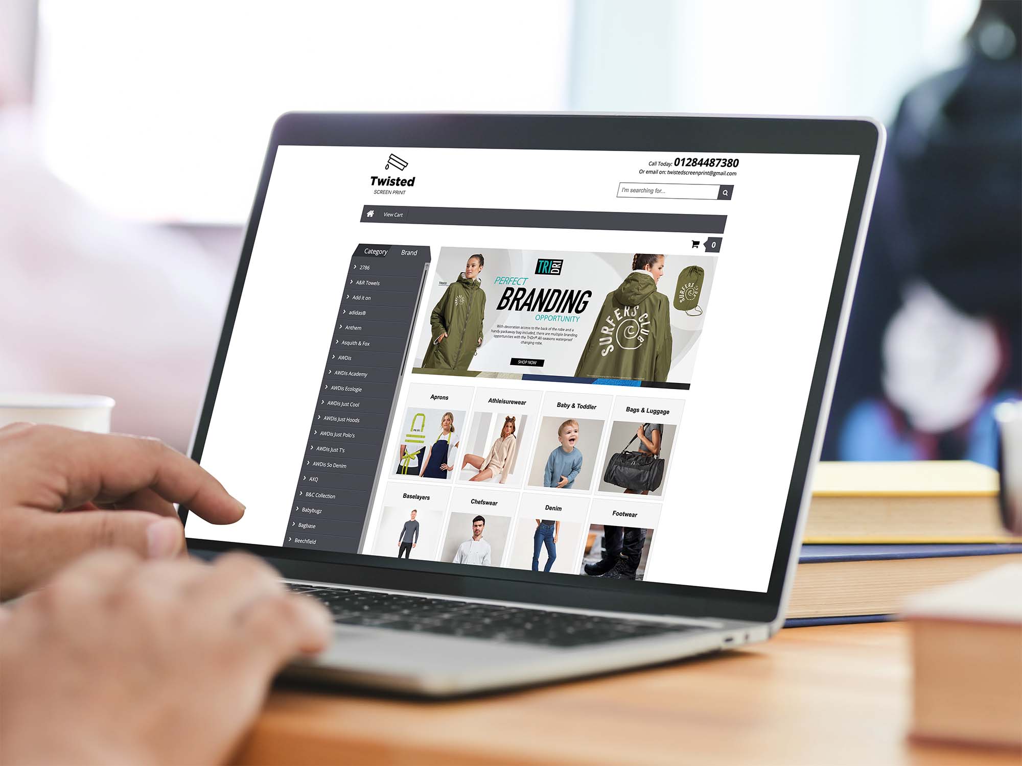 person-browsing-garment-catalogue-website-on-laptop Person browsing garment catalogue website on laptop